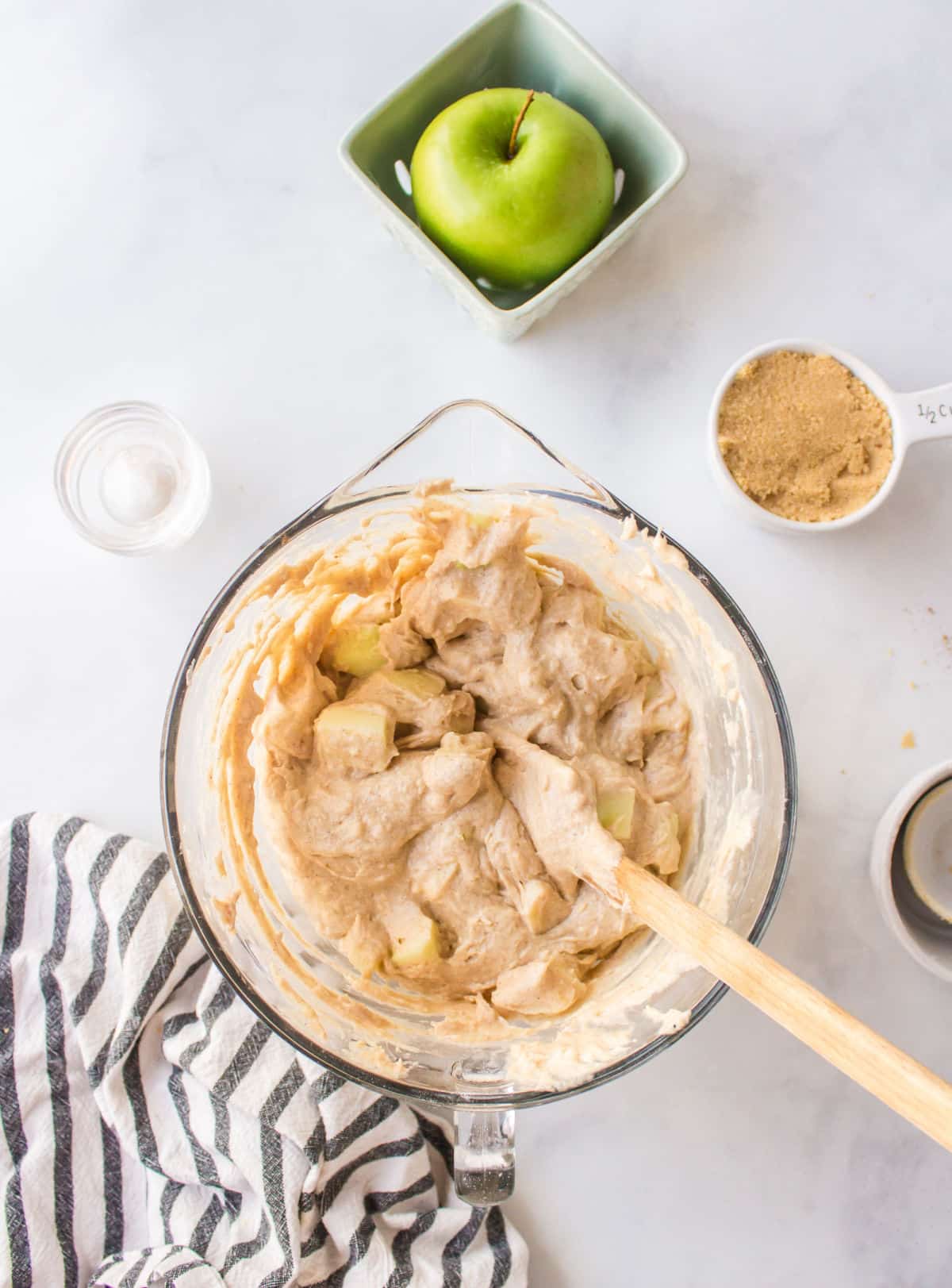 Apple chunks folded into muffin batter.