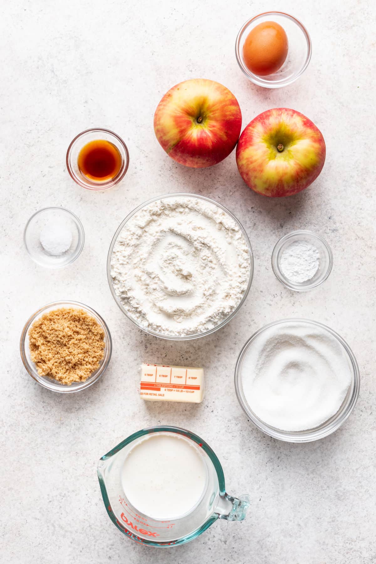 Ingredients for apple upside down cake in dishes.