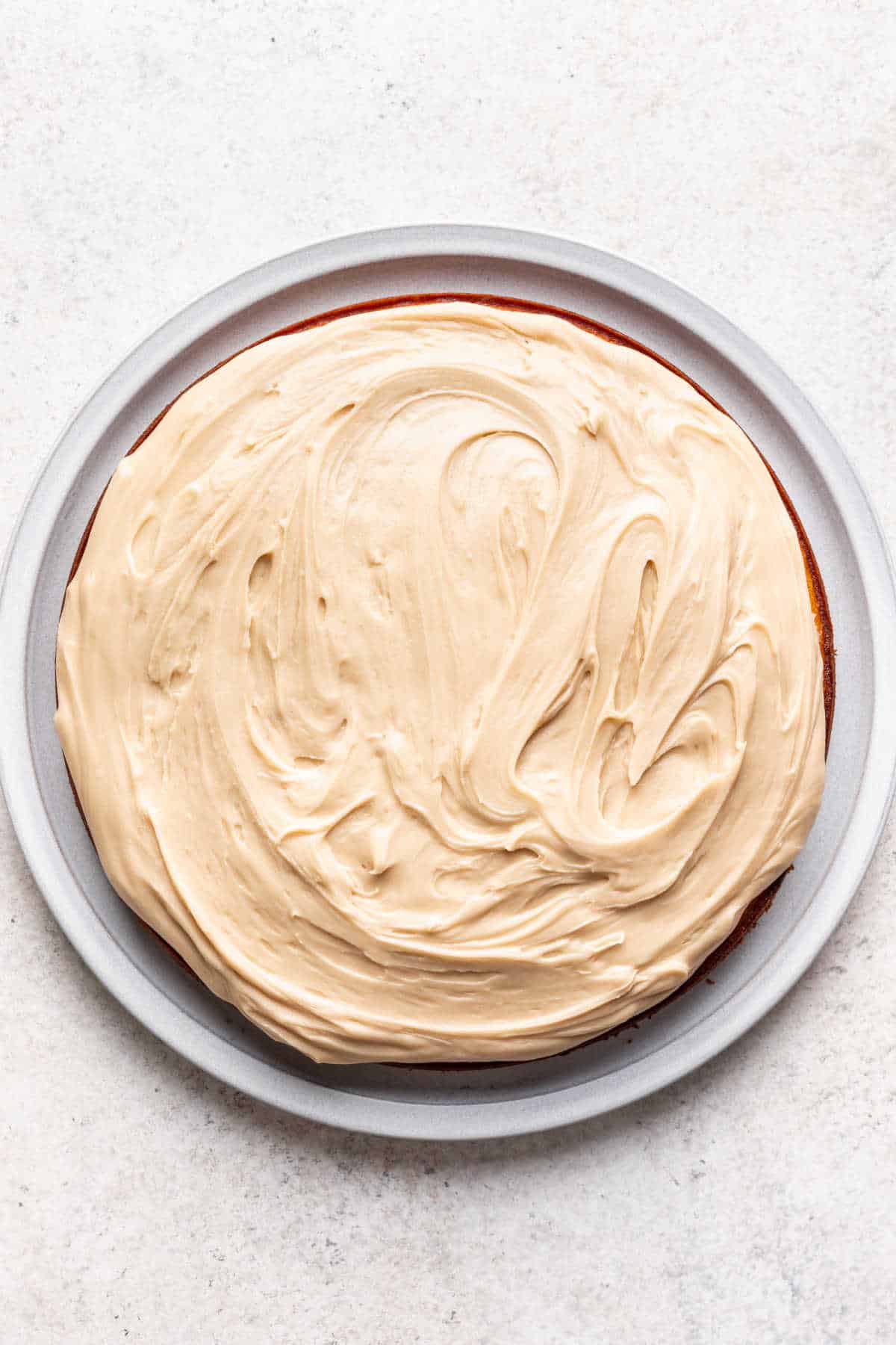 A thick layer of caramel frosting over a cake.