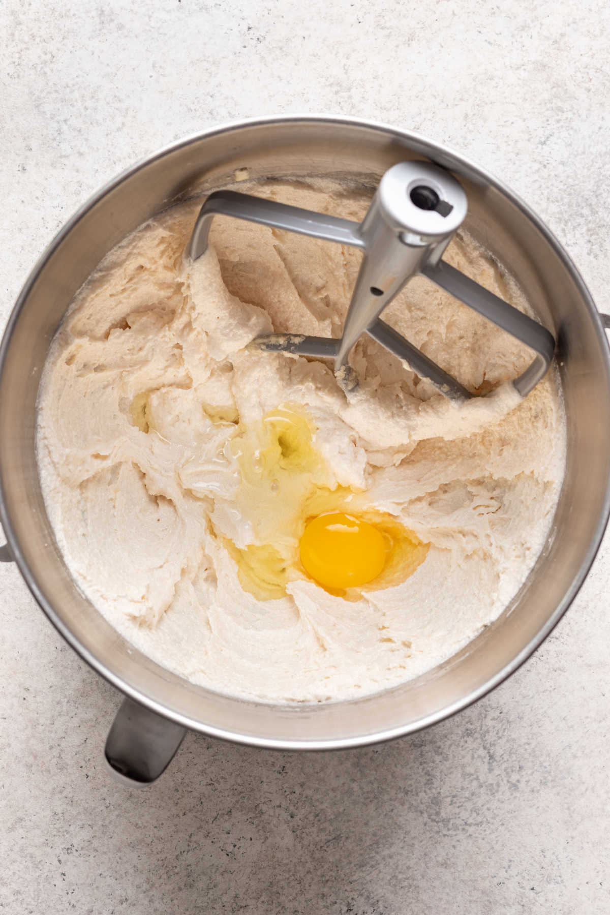 Mixing eggs and egg yolks into creamed butter mixture.