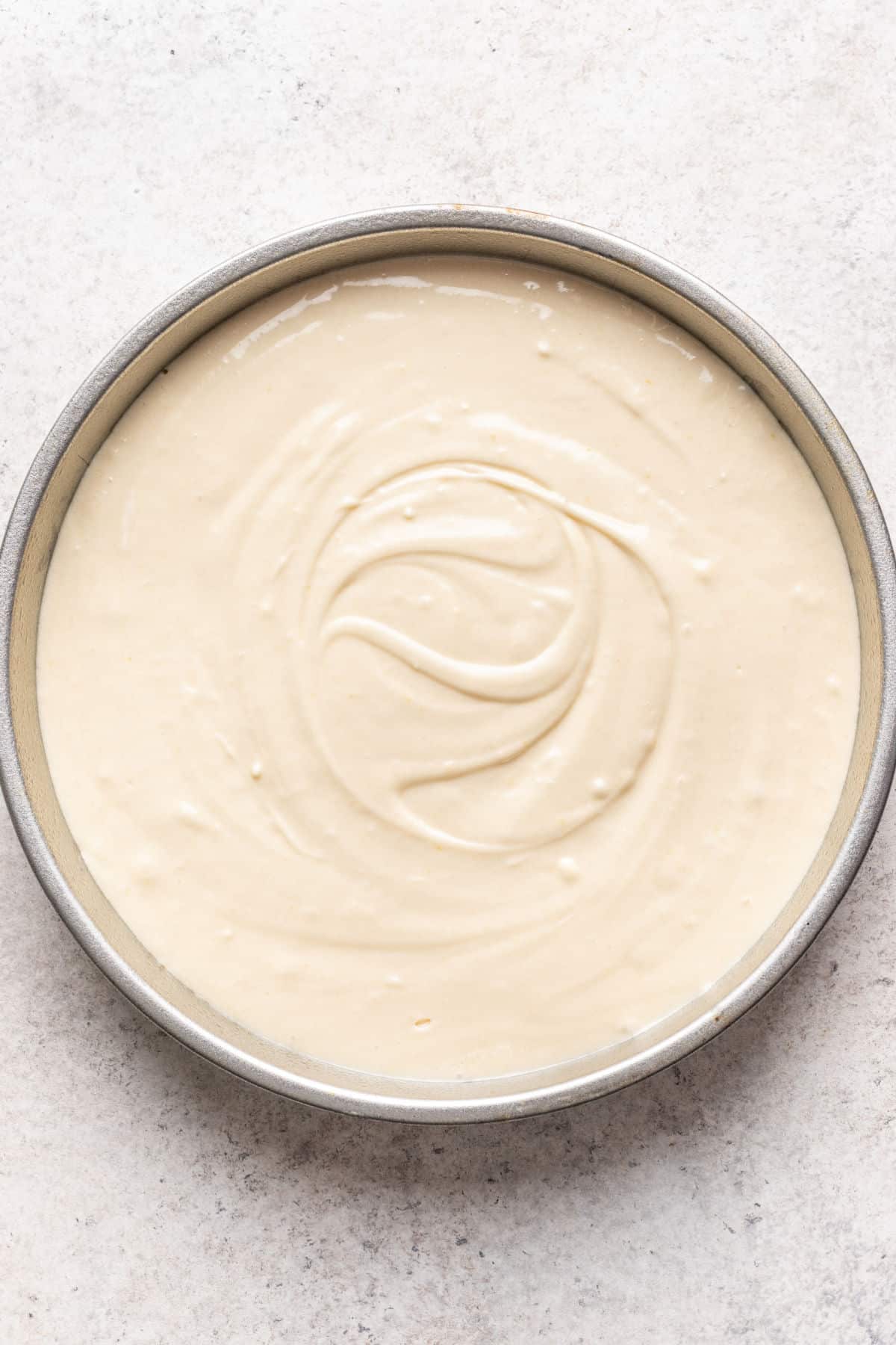 Caramel cake batter in a cake pan.