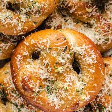 Garlic parmesan pretzels stacked overlapping on top of each other.