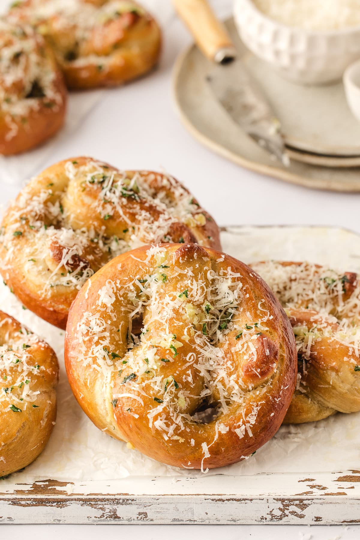 Garlic parmesan pretzels on a distressed cutting board.