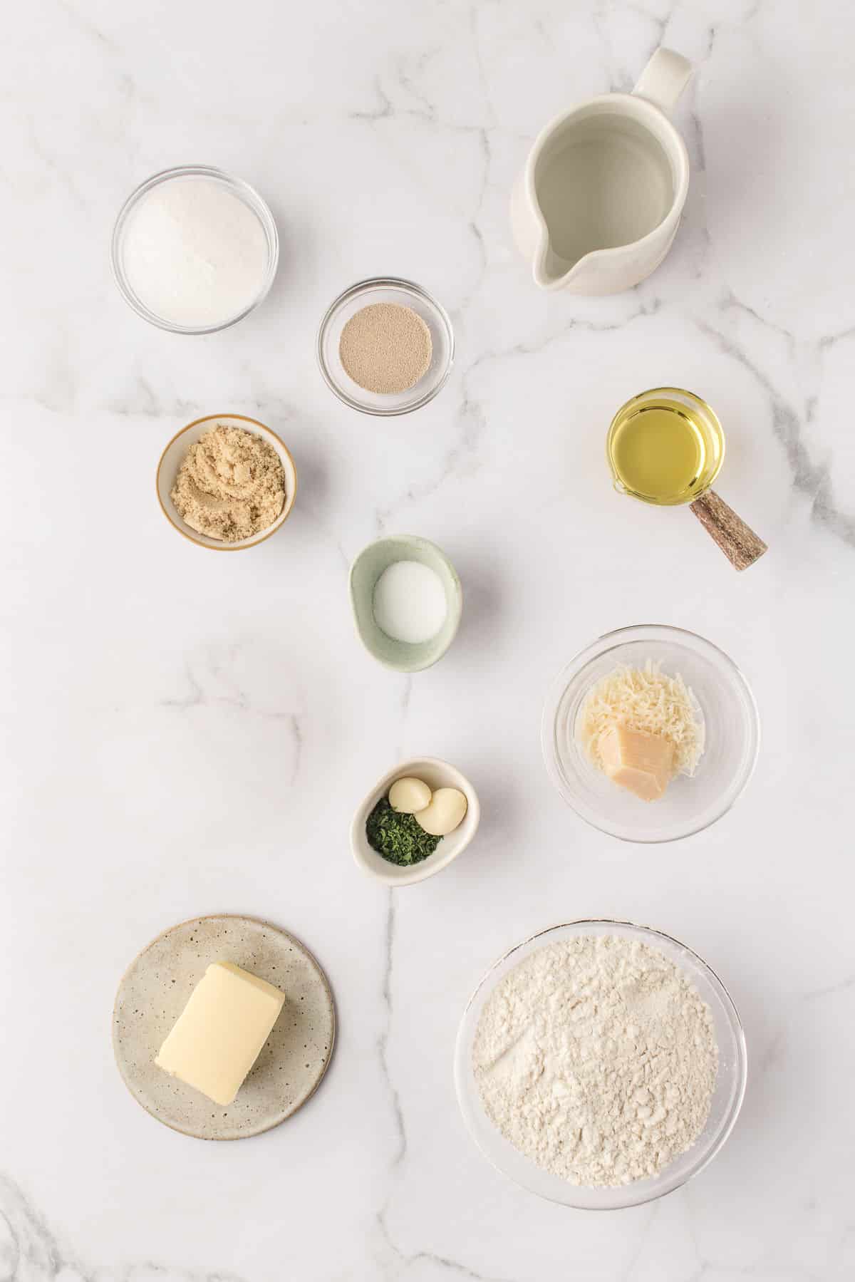 Ingredients for garlic parmesan pretzels in dishes.