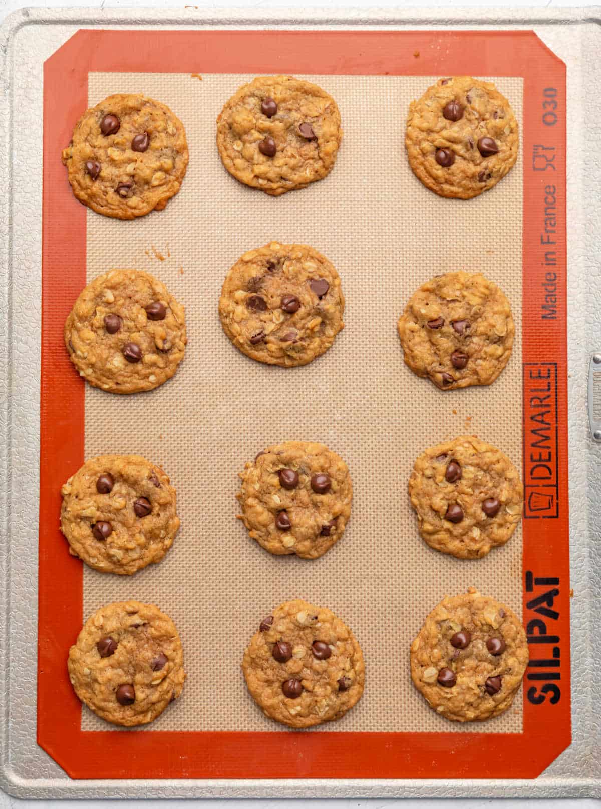 Baked pumpkin oatmeal cookies on a baking sheet.