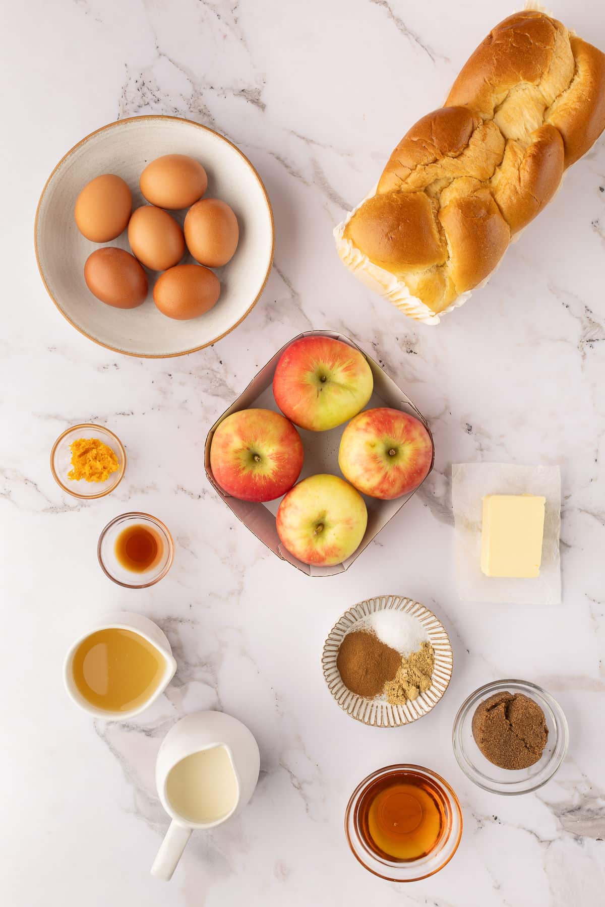 Ingredients for apple baked French toast in dishes.