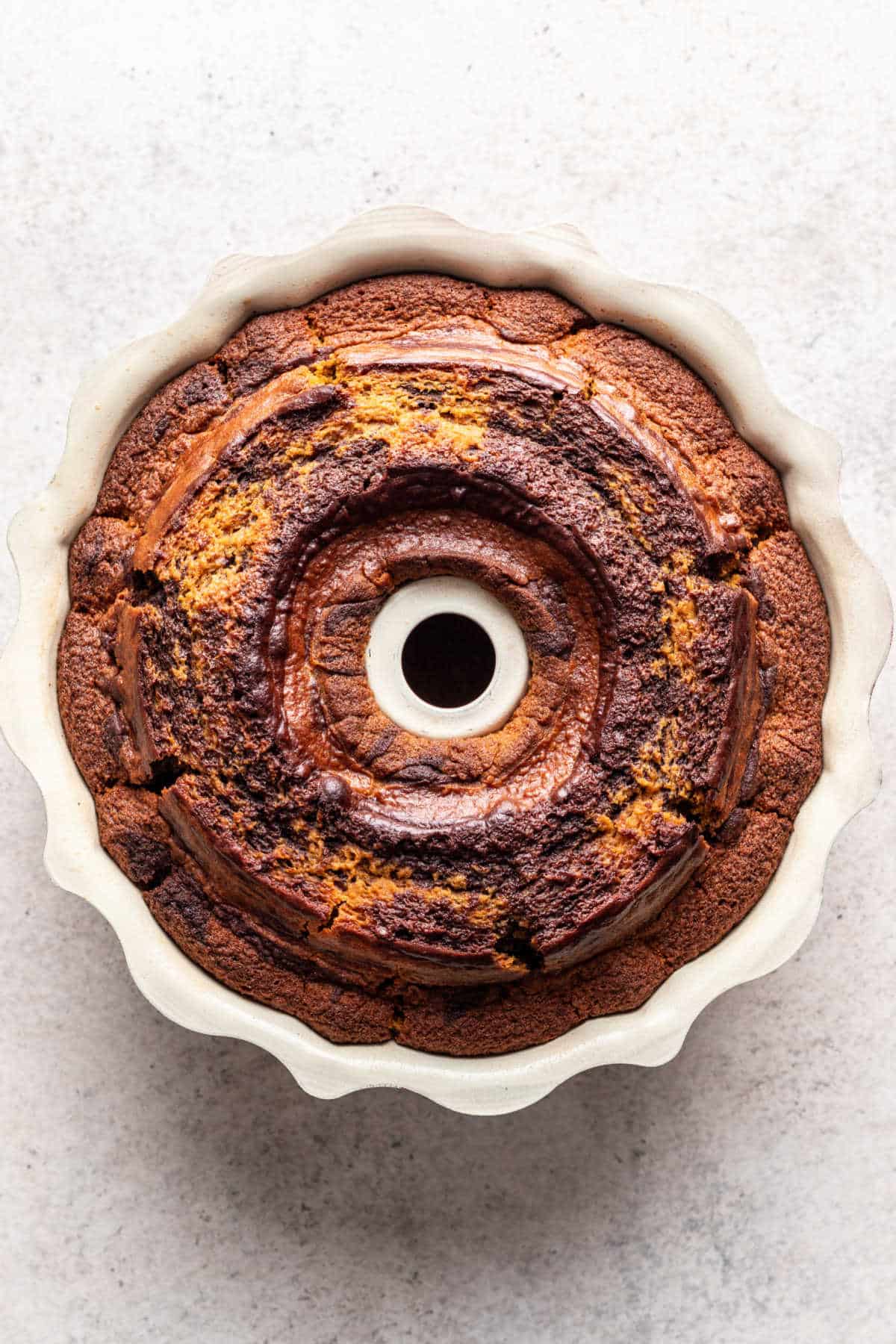 Baked pumpkin marble cake in a bundt pan.