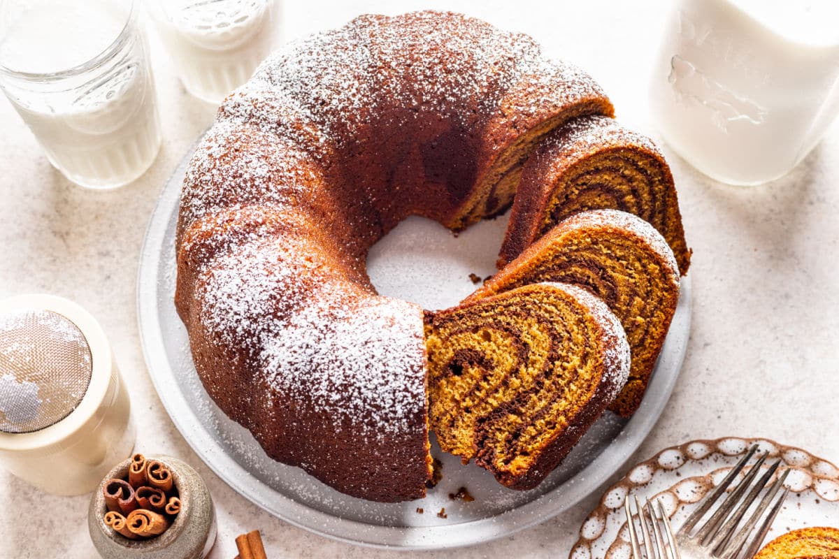 Pumpkin Marble Cake Three slices of cut pumpkin marble cake leaning against the cake.