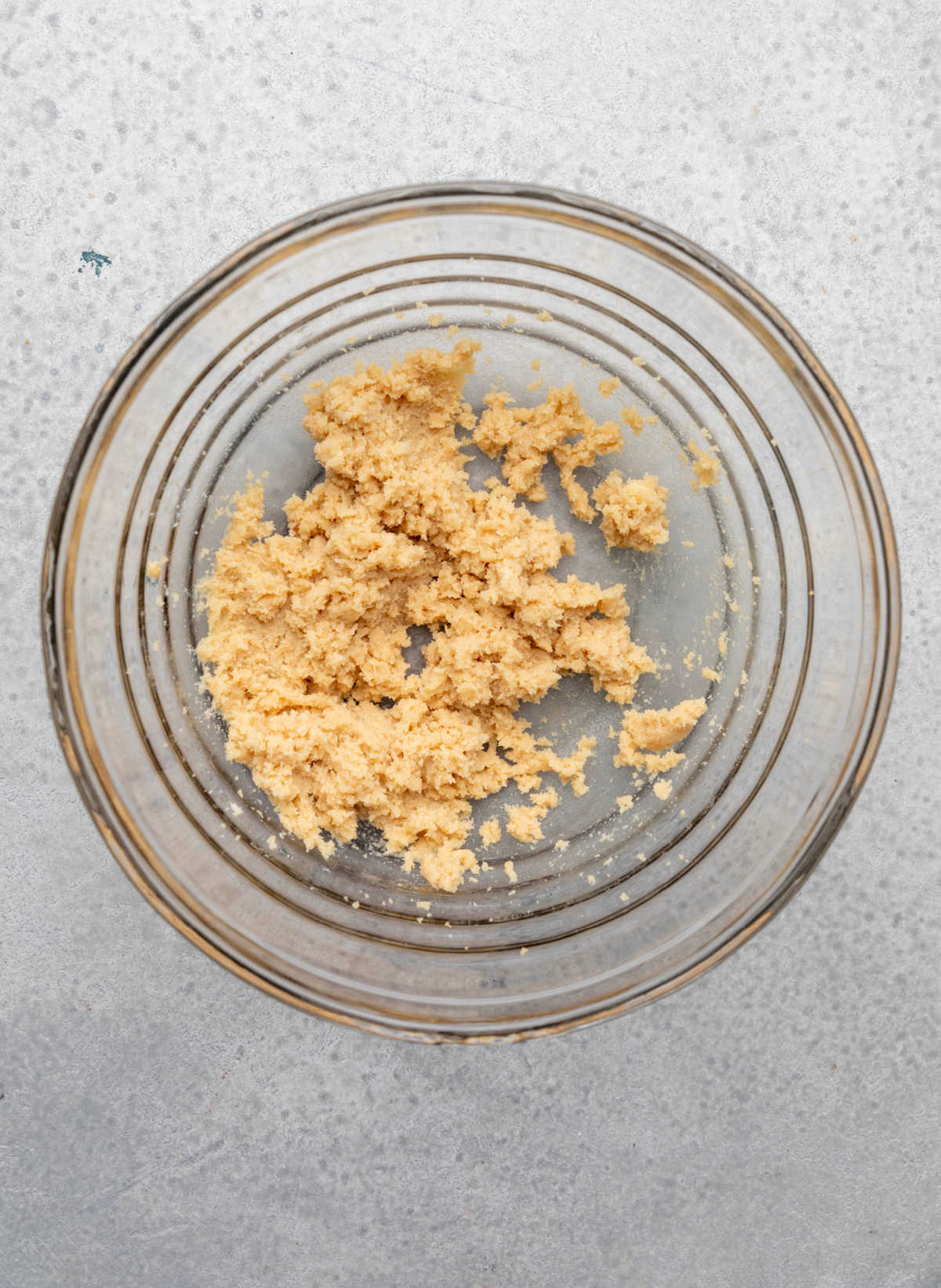 Creamed butter and sugar in a glass mixing bowl.