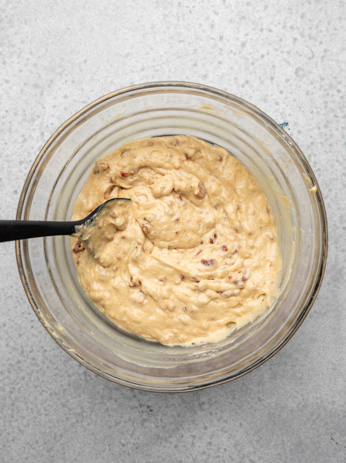 Chopped pecans mixed into date nut bread batter.