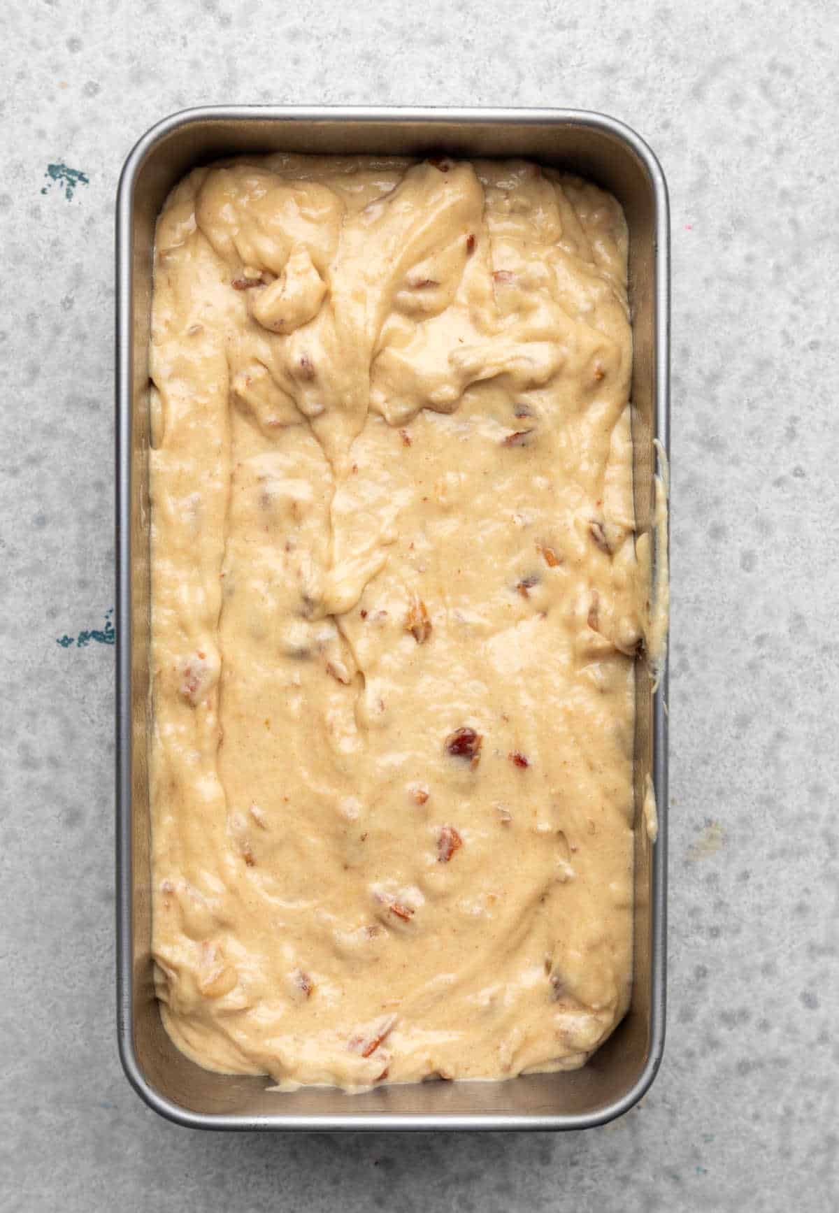 Date nut bread batter in a loaf pan.