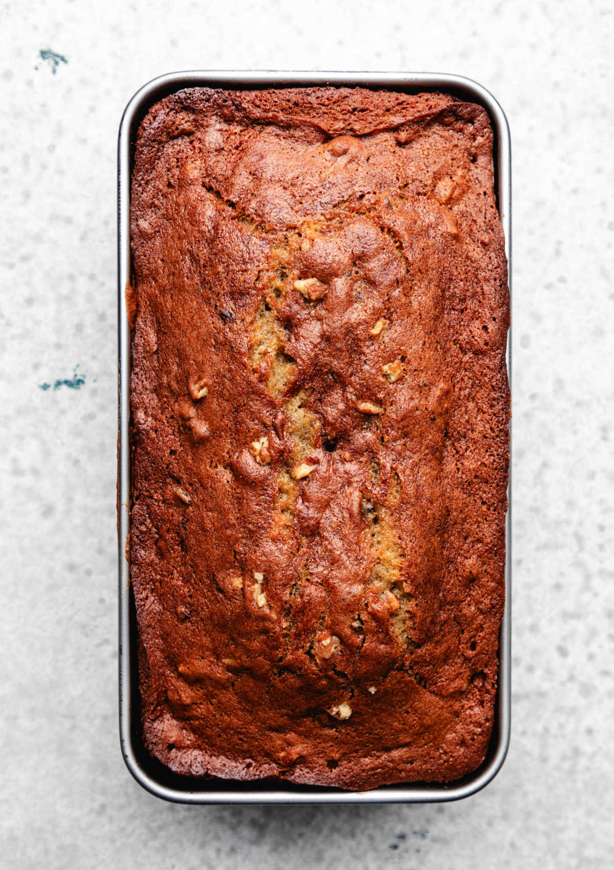 Baked date nut bread in a loaf pan.