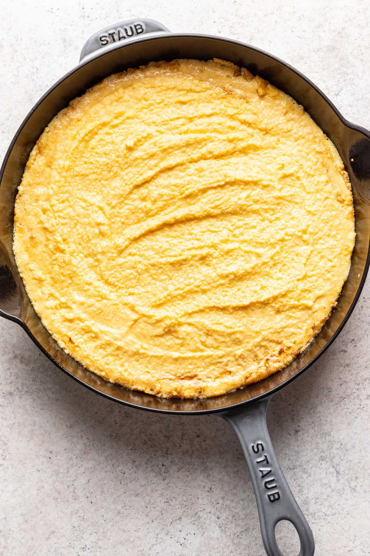 Cornbread batter in a cast iron skillet.