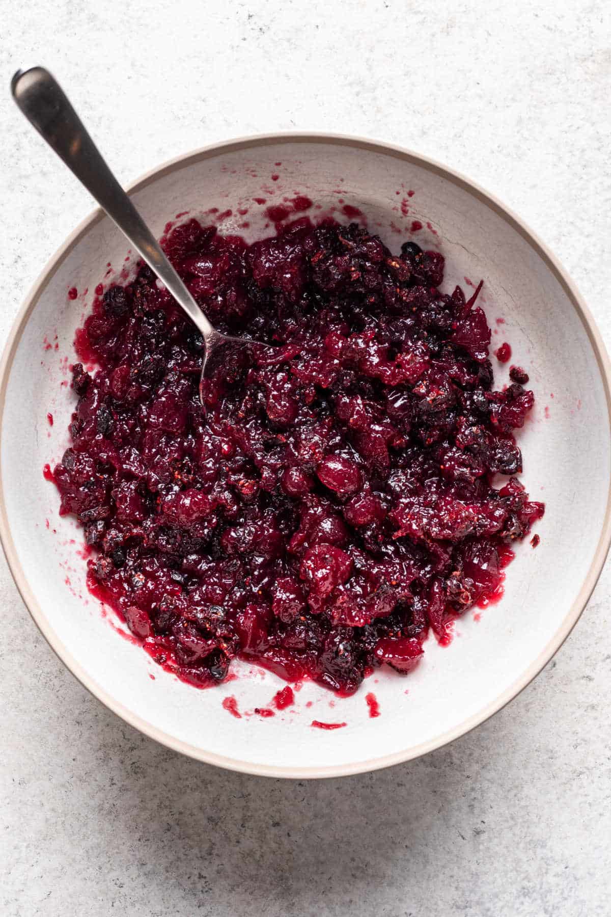 Cranberry sauce and chopped craisin mixture in a mixing bowl.