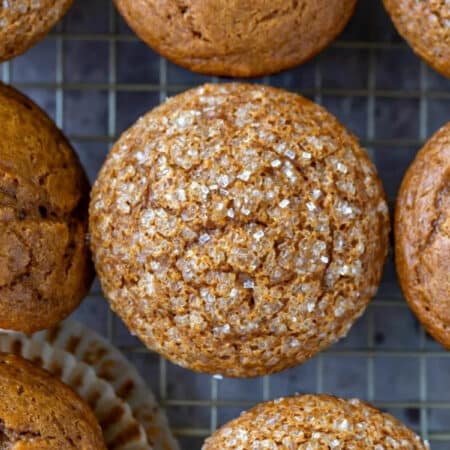 Rows of gingerbread muffins on wire cooling rack.