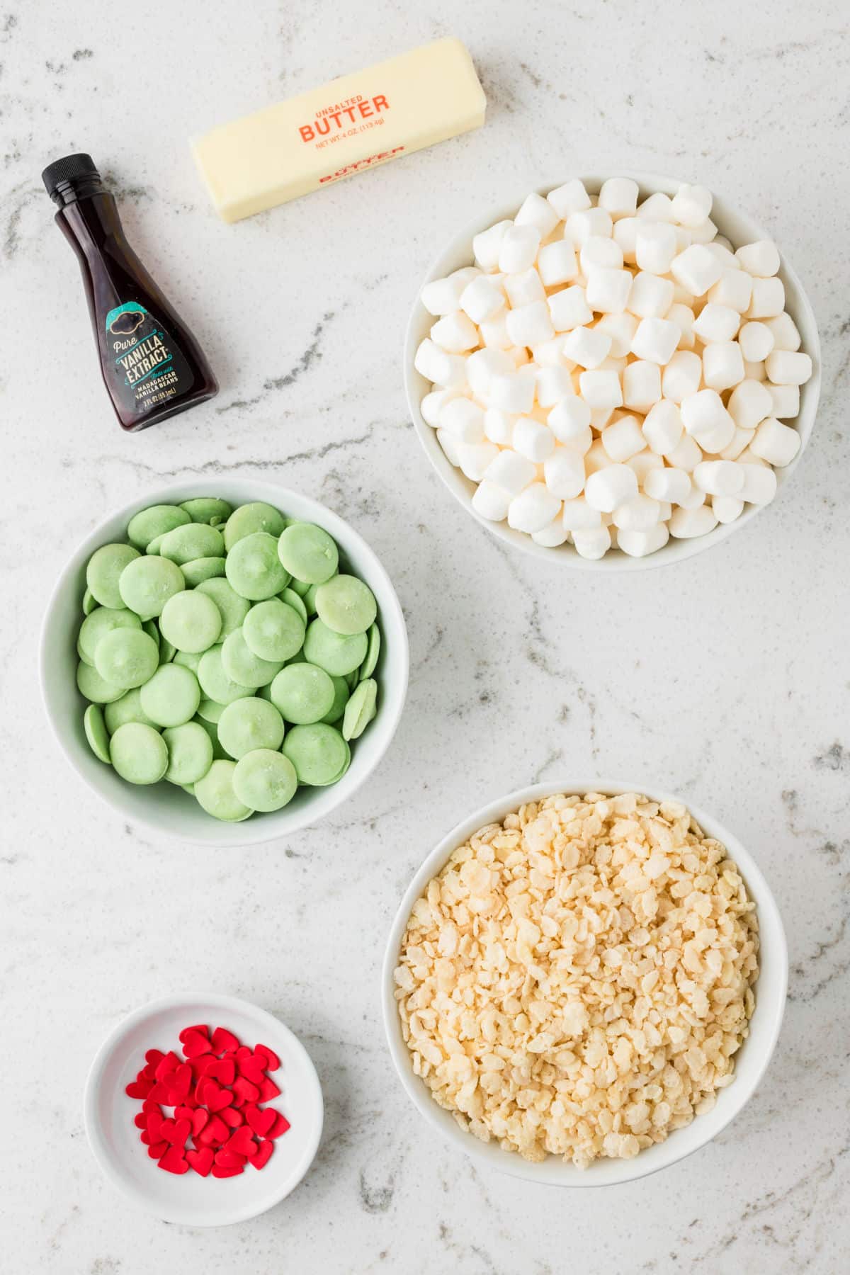 Ingredients for Grinch Rice Krispies Treats in dishes.