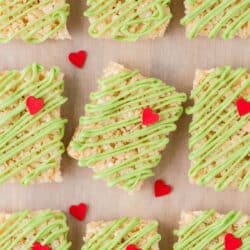 A row of Grinch Rice Krispies treats with the center one tilted.