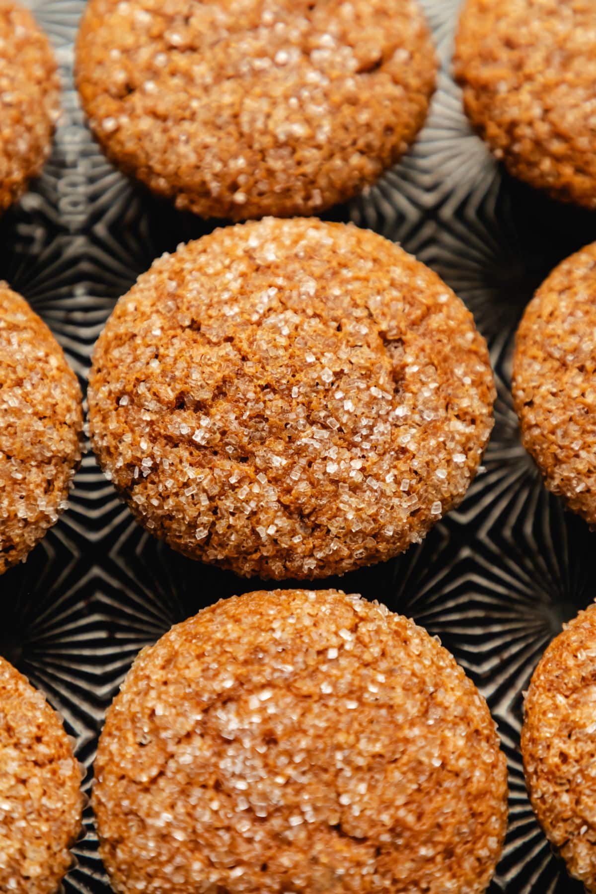 Rows of gingerbread muffins on a vintage baking sheet.