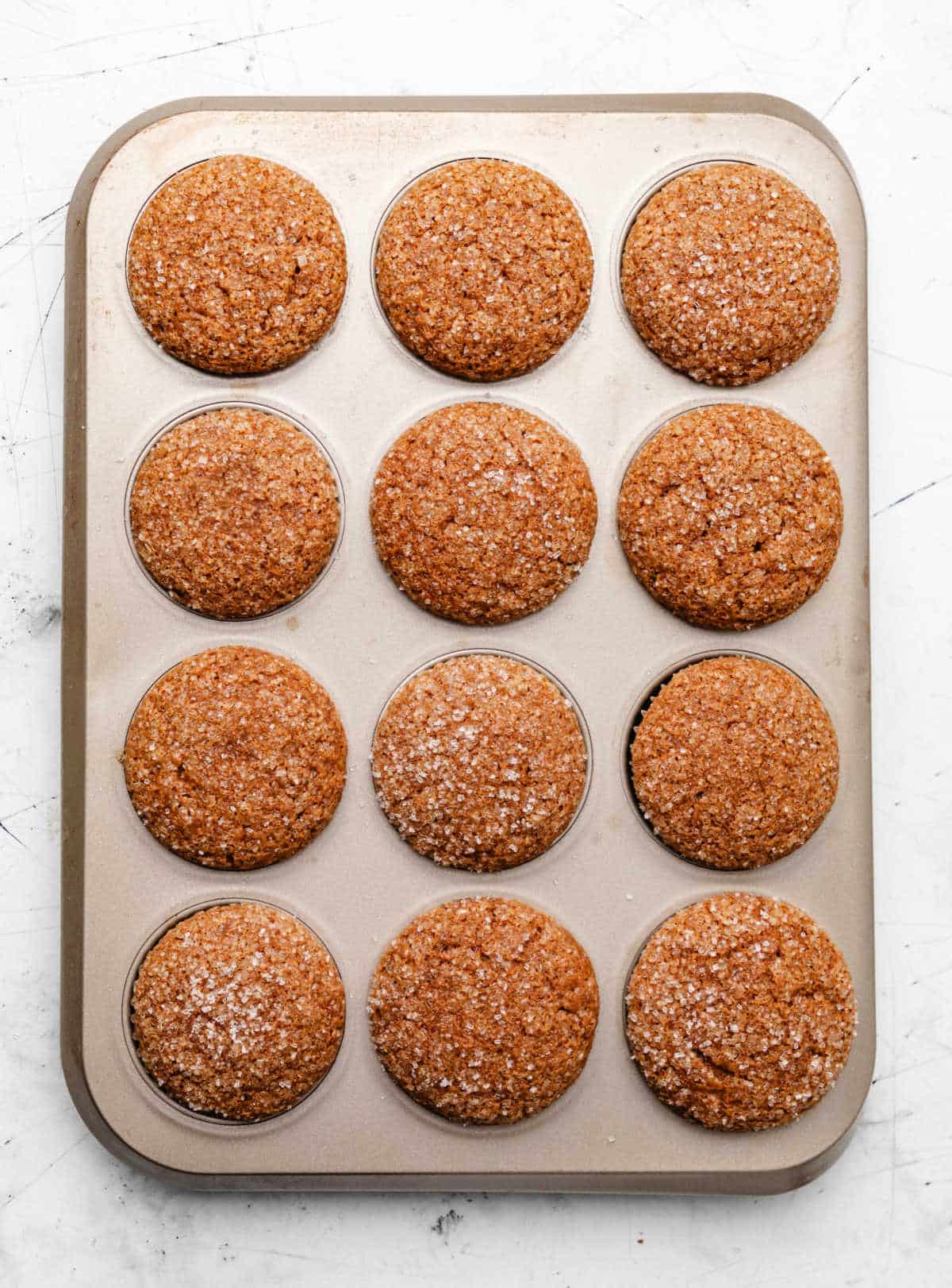 Baked gingerbread muffins in a muffin tin.