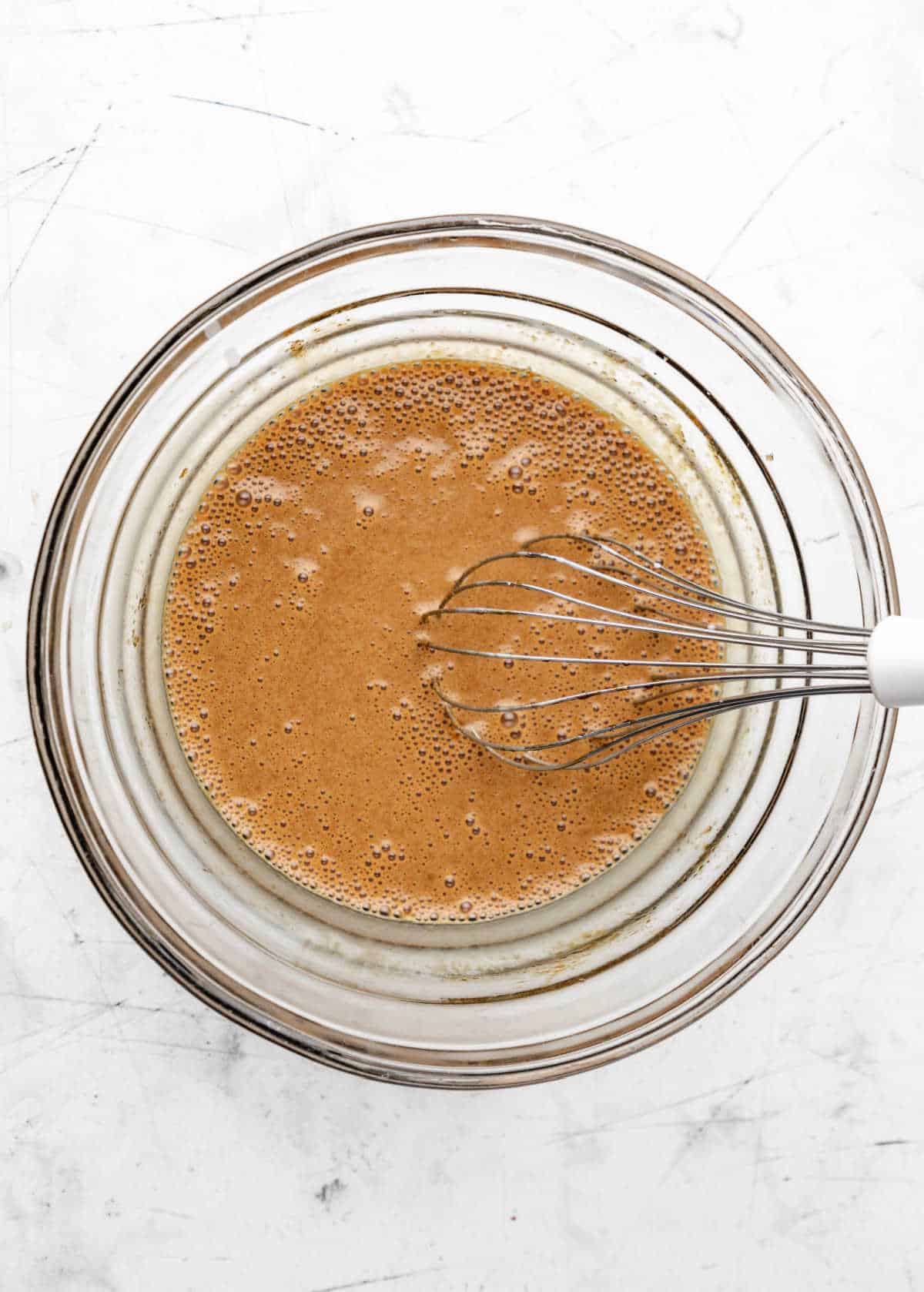 Buttermilk whisked into molasses oil and sugar mixture.