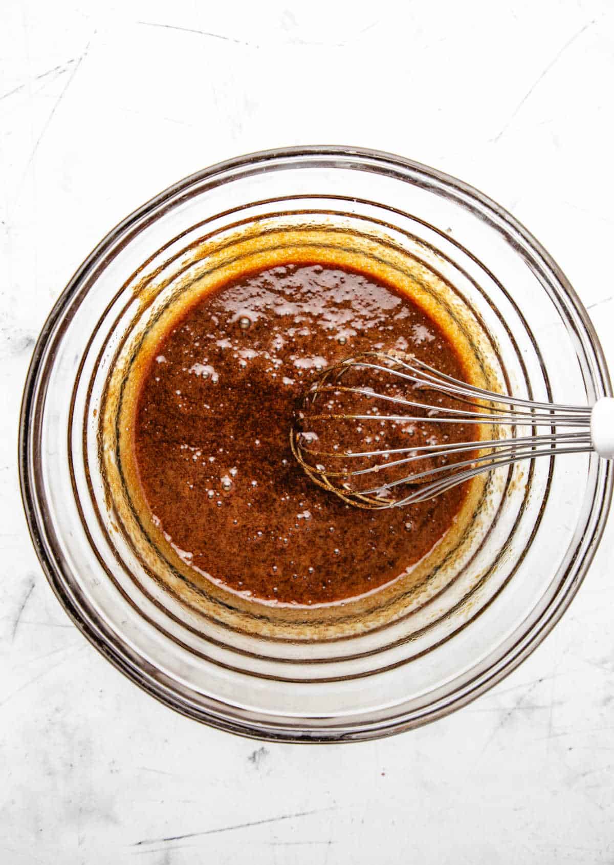 Egg whisked into molasses sugar and oil mixture.