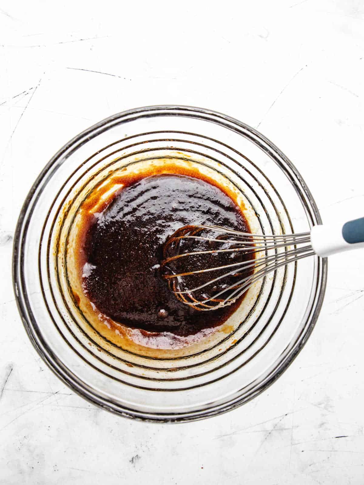 Molasses mixed into oil and sugar mixture.