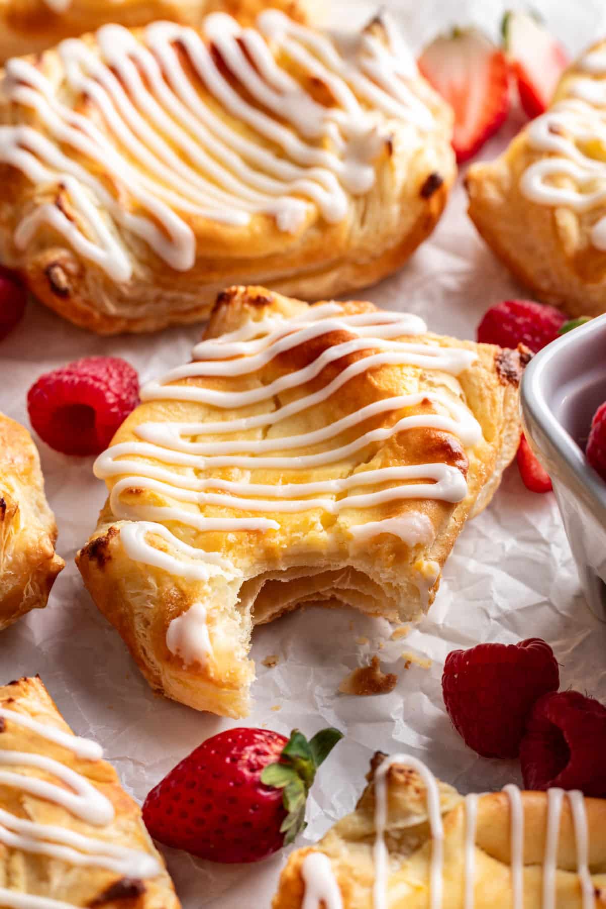 A homemade Cheese Danish with a bite out of it.