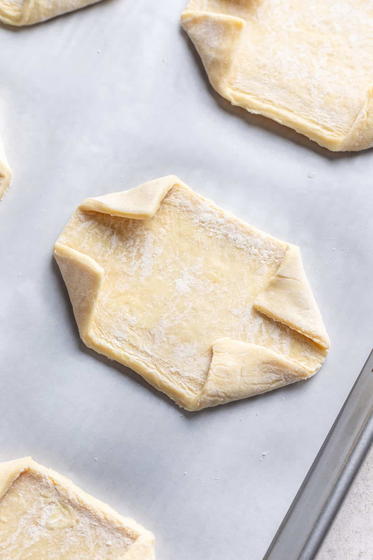 A piece of puff pastry with the corners folded in.