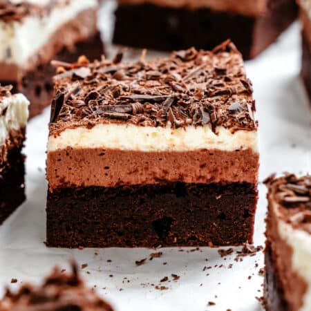 A french silk brownie on a piece of white parchment paper.