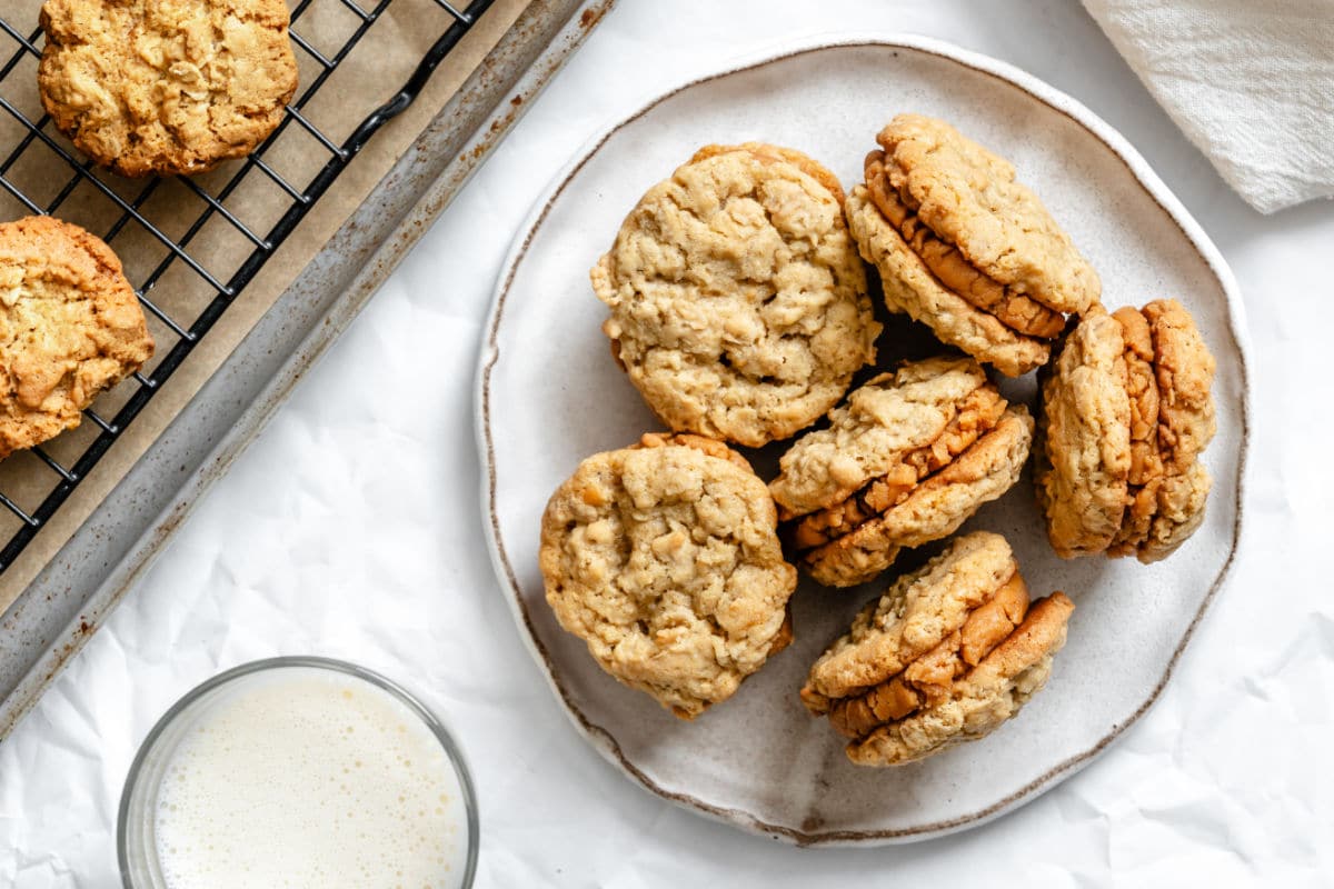 Oatmeal Cookies with Peanut Butter Filling A plate of Do-Si-Dos cookies next to the baking sheet of cookies.