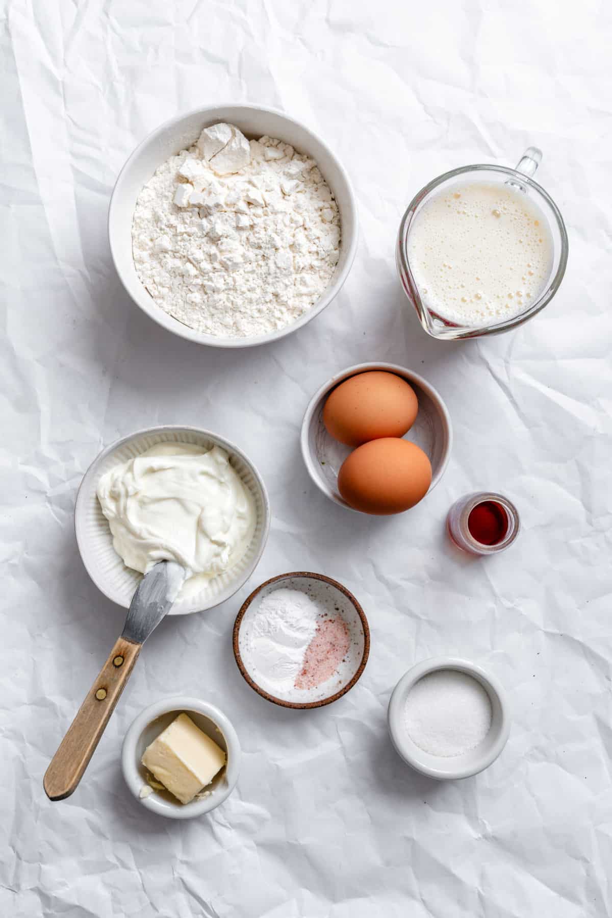 Ingredients for sour cream pancakes in dishes.