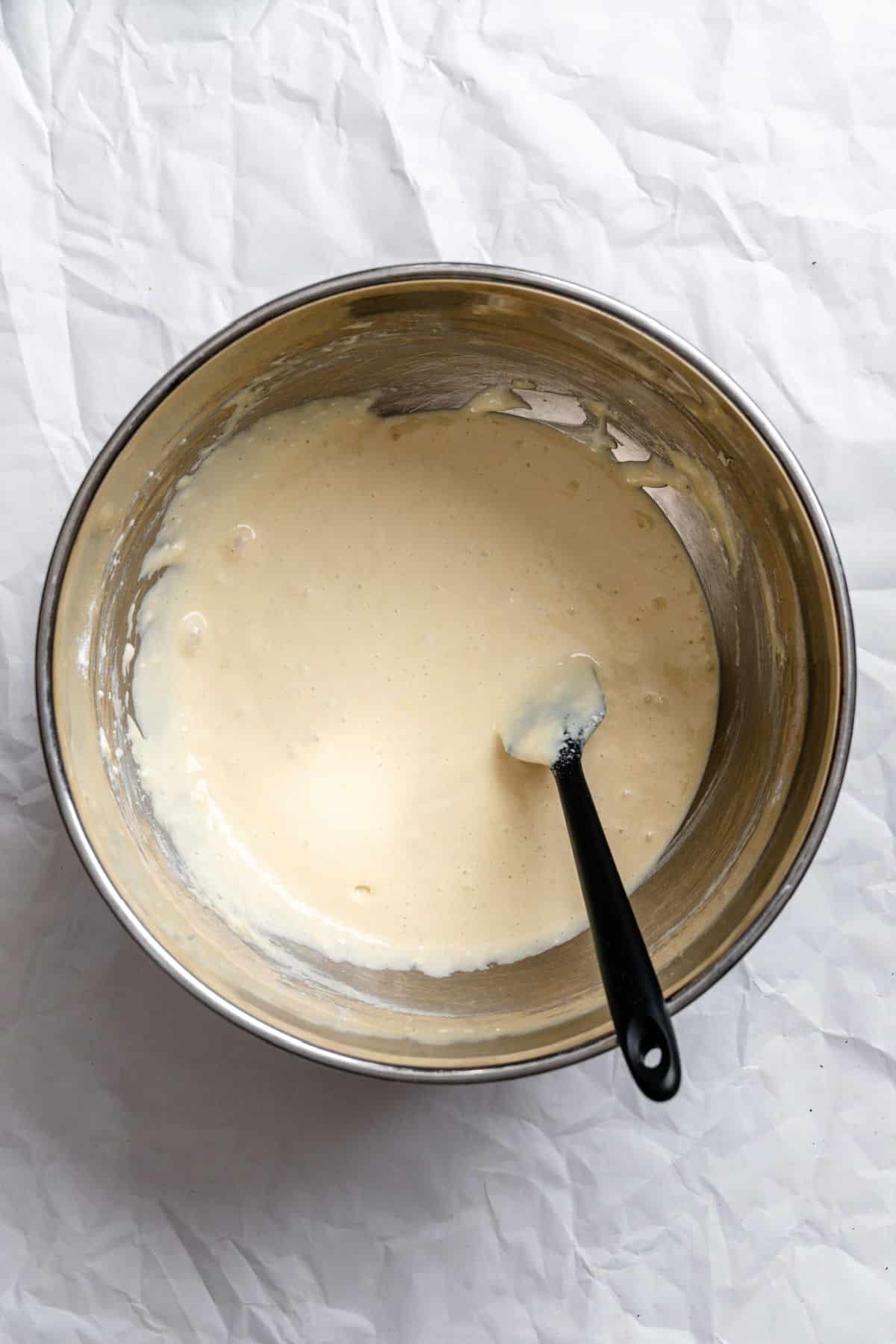 Wet ingredients mixed into dry ingredients for sour cream pancakes.