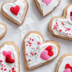 Valentine's Day sugar cookies on a piece of white parchment paper.