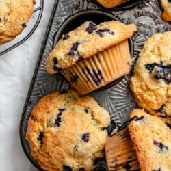 Bakery style blueberry muffins in a vintage muffin tin.