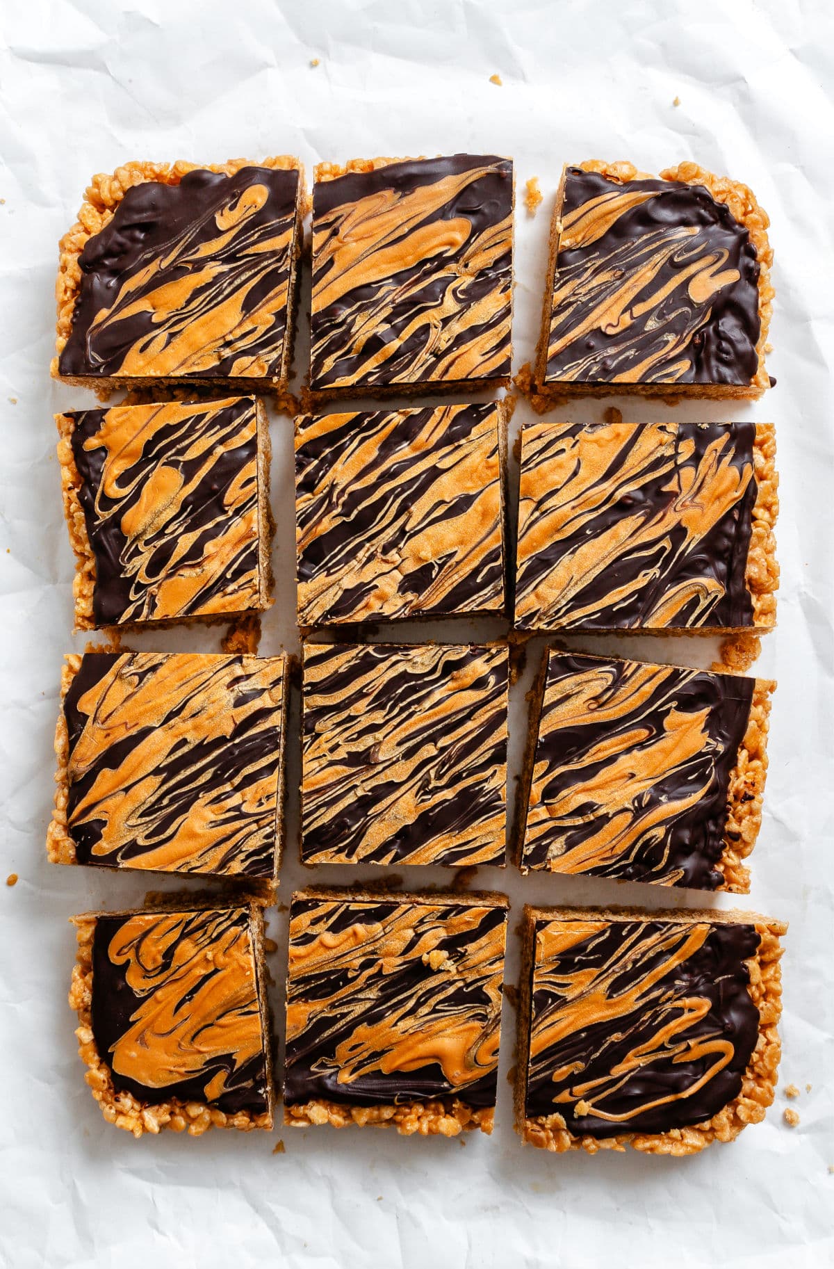 Butterscotch Rice Krispie Treat A pan of cut butterscotch rice krispie treats on parchment paper.