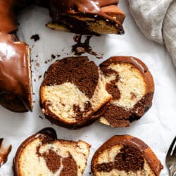 Four slices of marble bundt cake next to the cake.