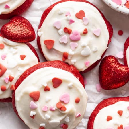 Overlapping Red Velvet Cupcake cookies topped with Valentine's Day sprinkles.