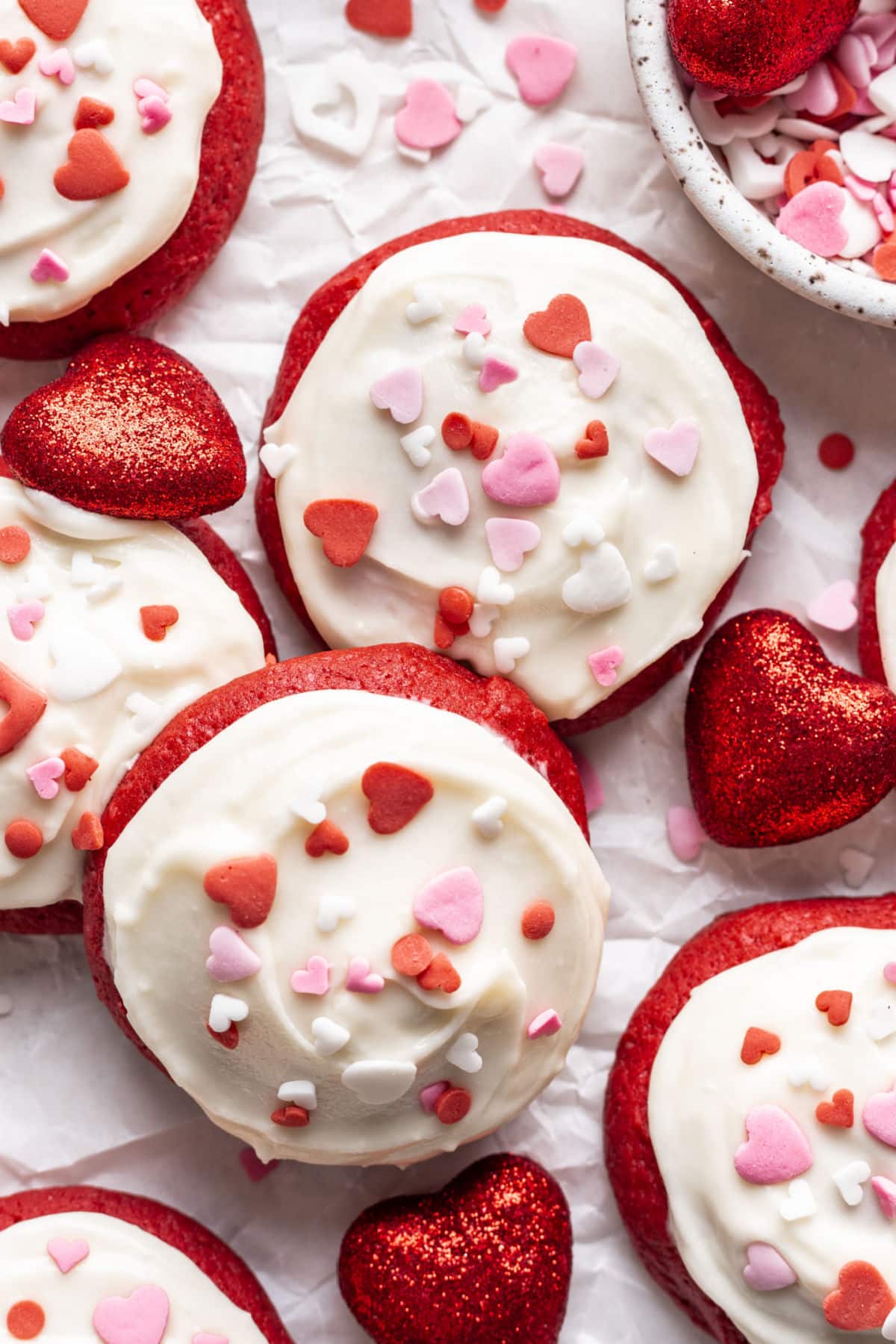 Overlapping Red Velvet Cupcake cookies topped with Valentine's Day sprinkles.