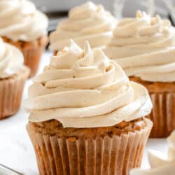 Piped brown sugar frosting on cupcakes.