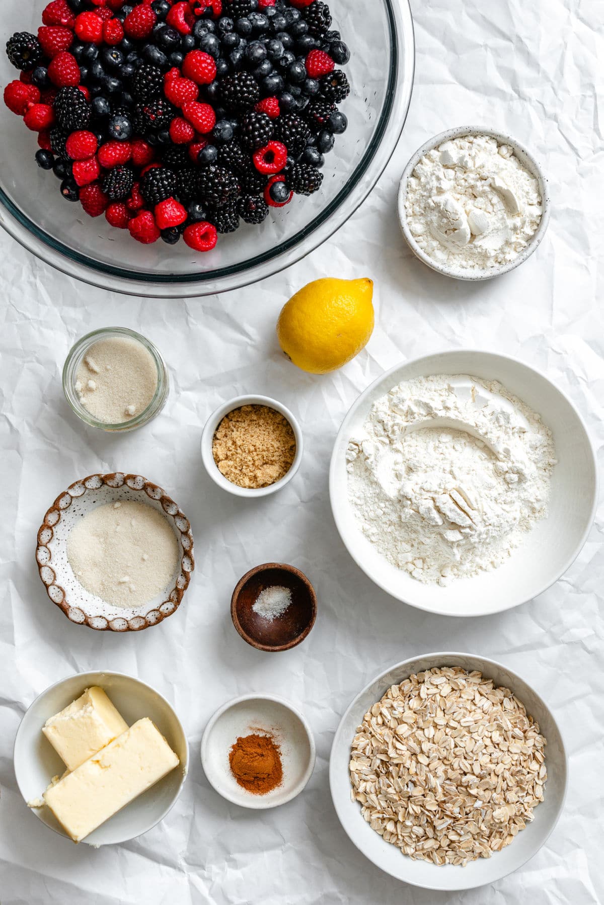 Ingredients for triple berry crisp in dishes.