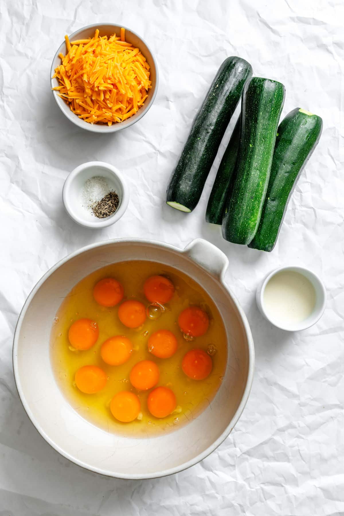Ingredients for zucchini frittata in dishes.