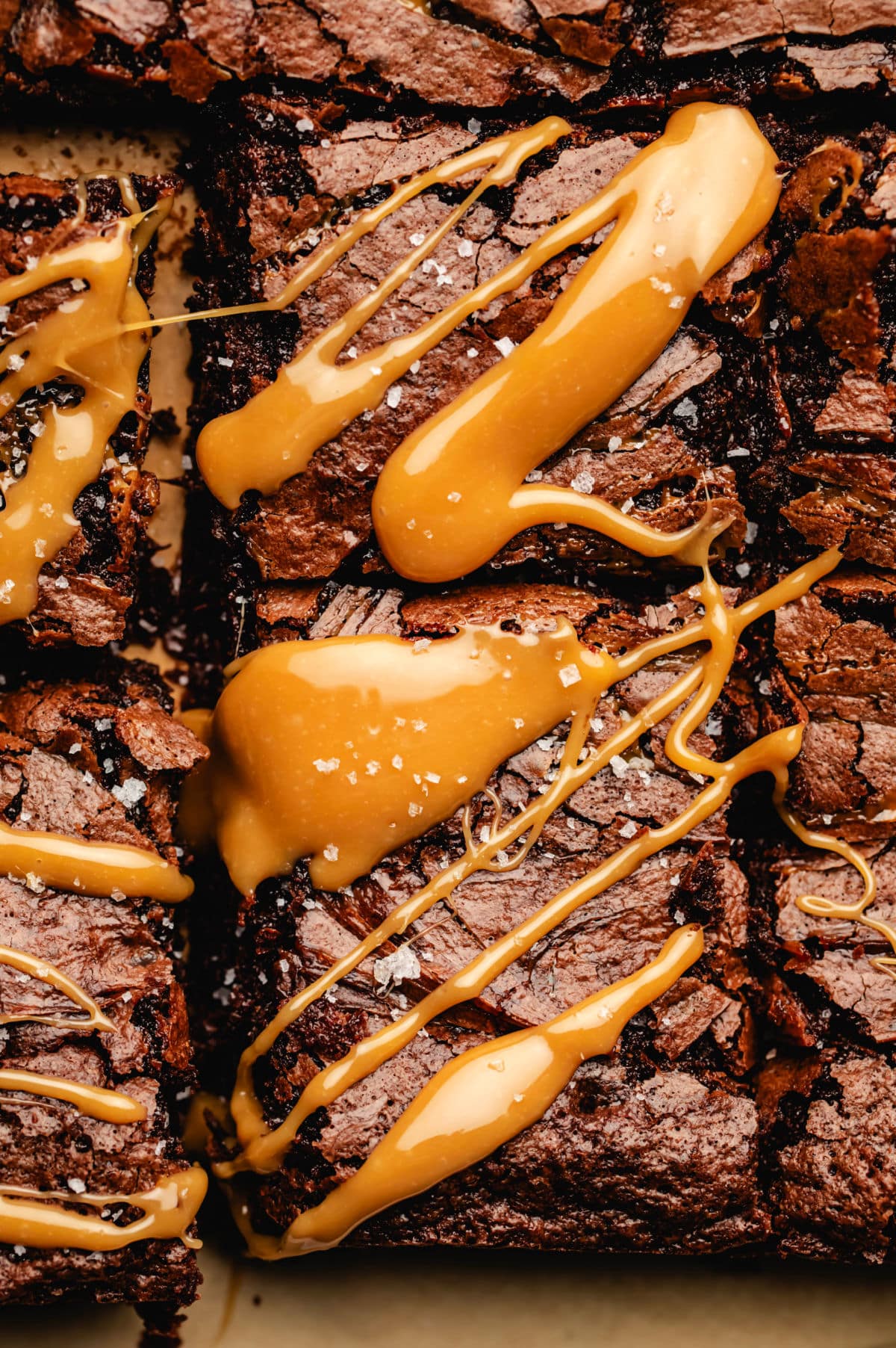 Cut caramel brownies drizzled with caramel.