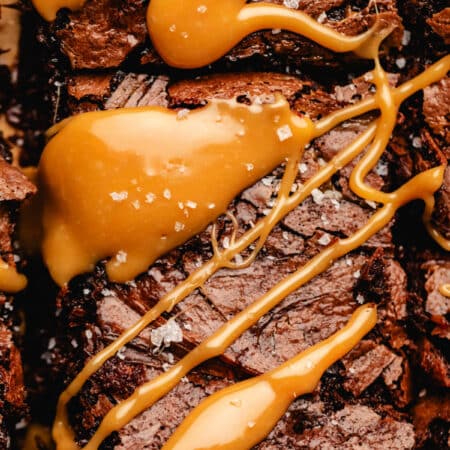 A caramel brownie topped with a drizzle of caramel and a sprinkle of salt.