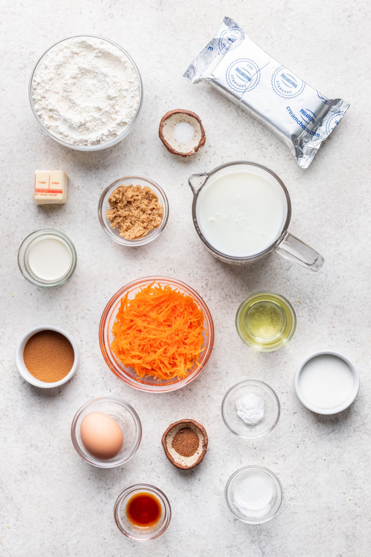 Ingredients for carrot cake pancakes in dishes.