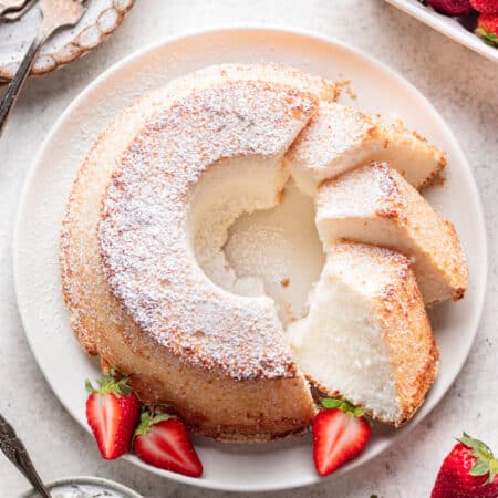 A chiffon cake with three pieces cut at an angle next to the cake.