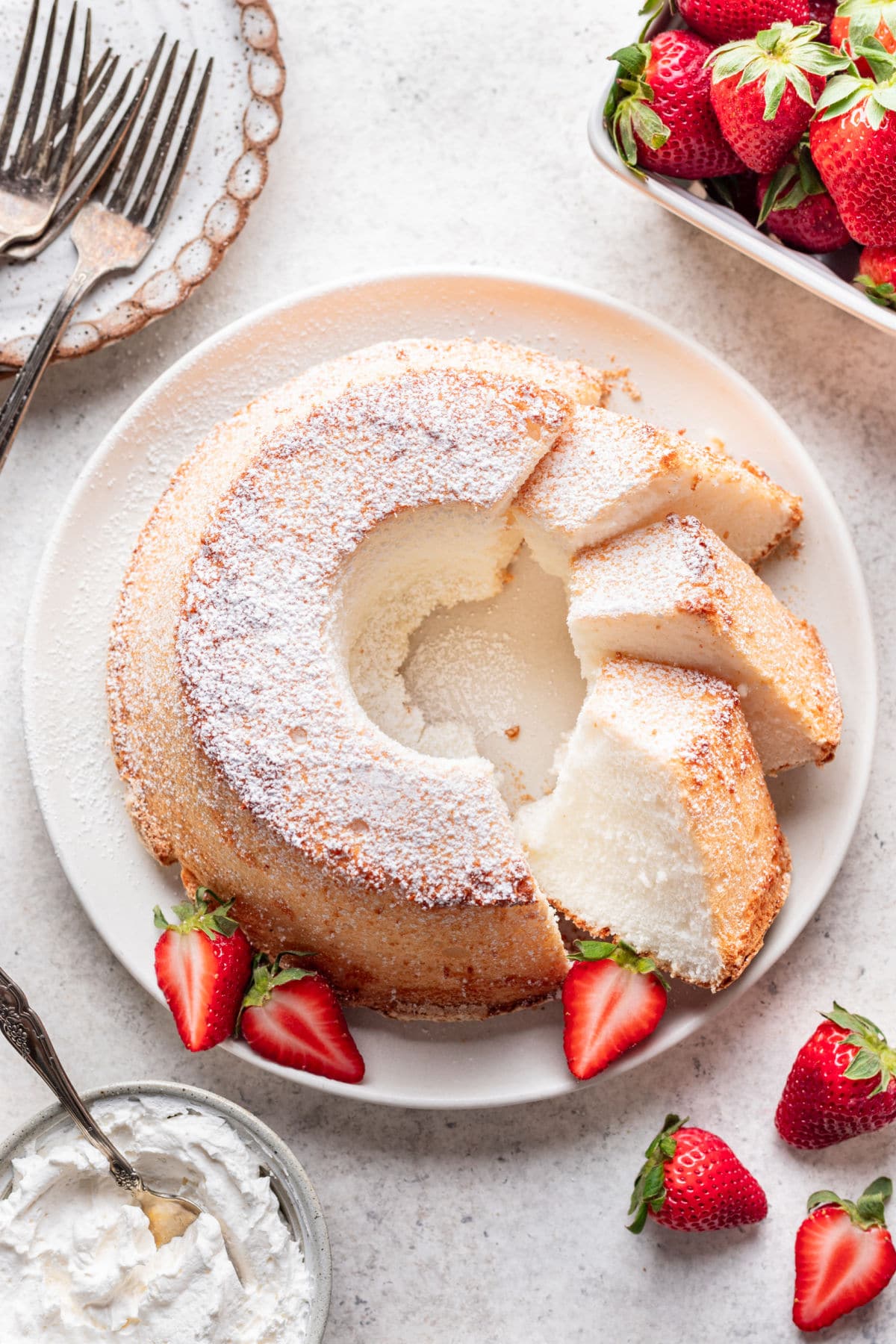 A chiffon cake with three pieces cut at an angle next to the cake.