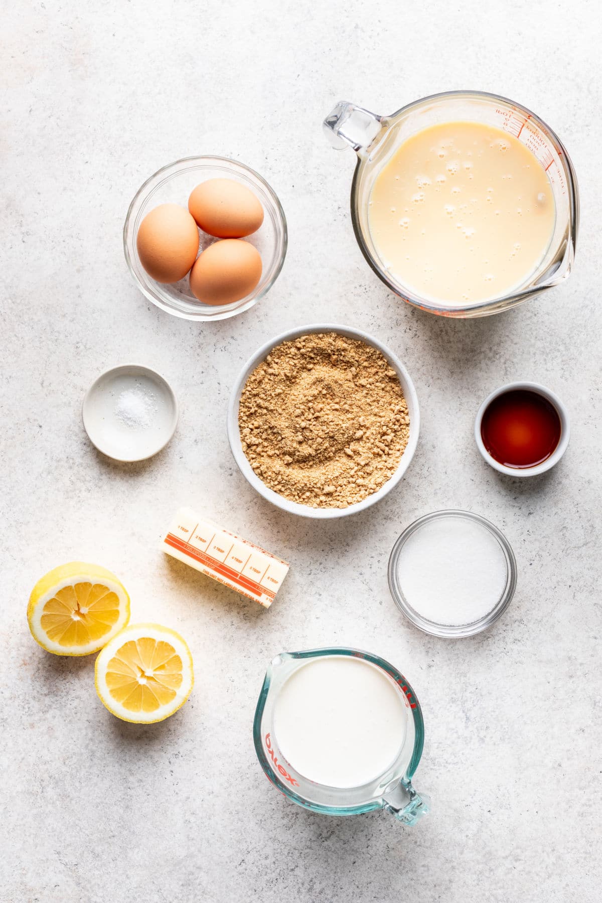Ingredients for lemon pie  with graham cracker crust in dishes. 