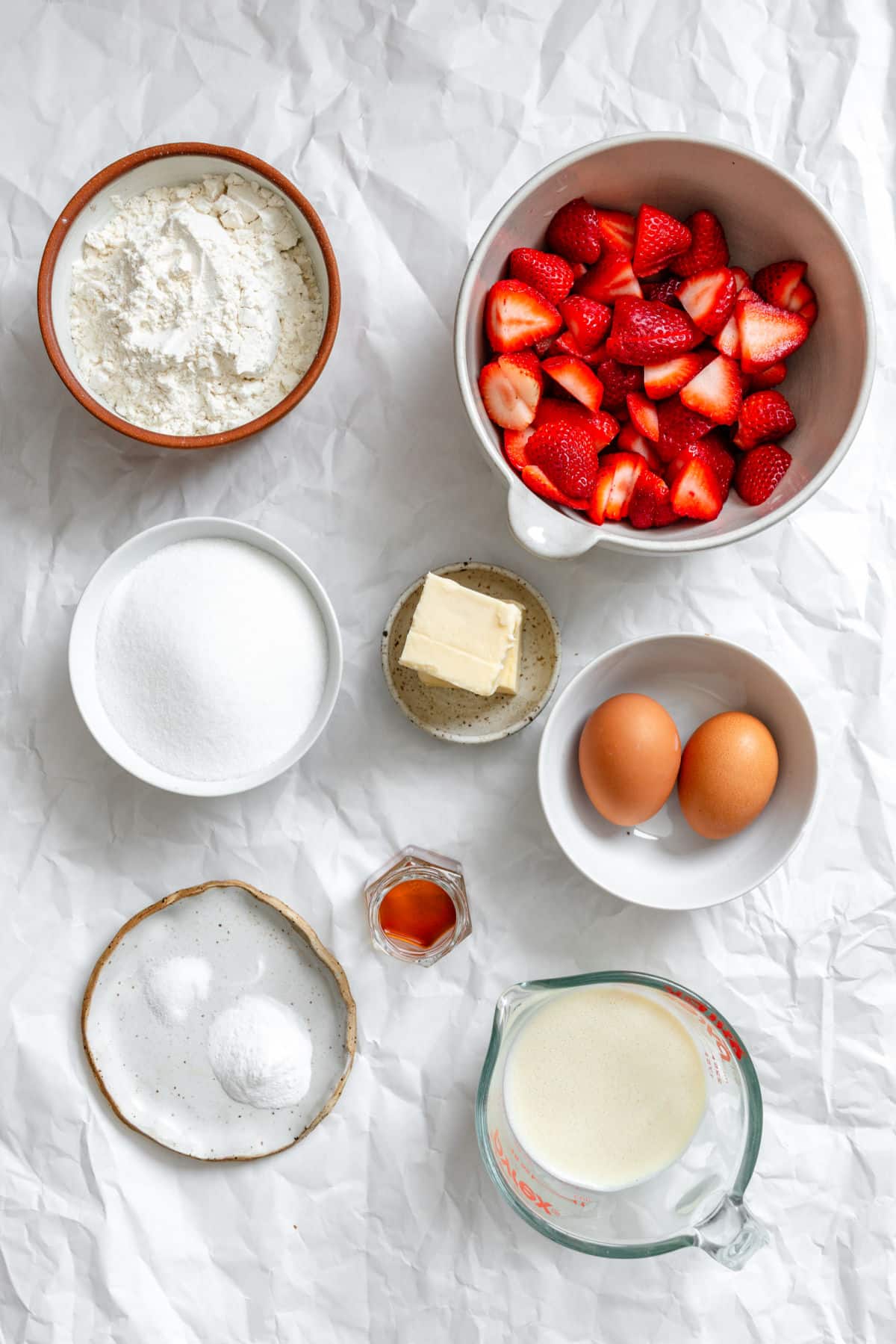 Ingredients for strawberry shortcake bars in dishes.
