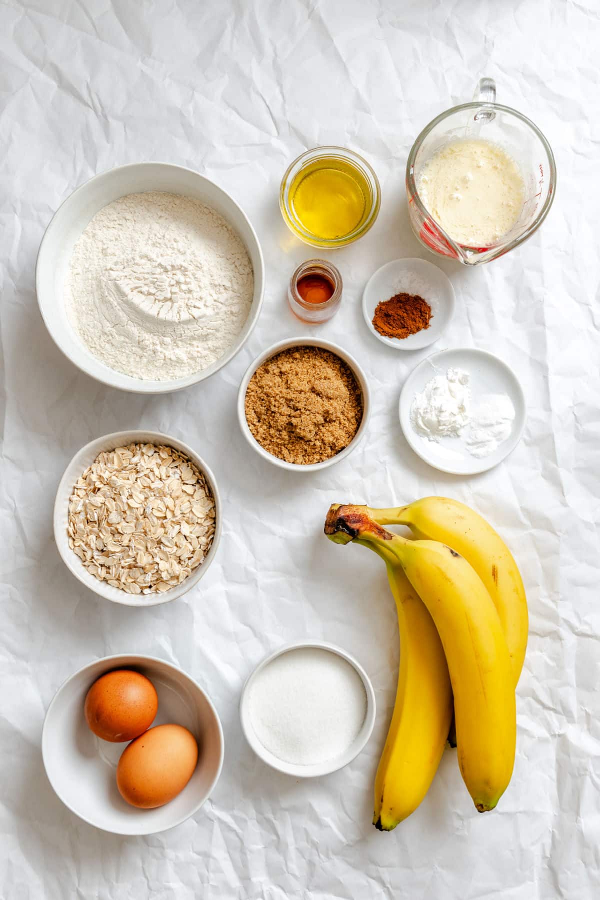 Ingredients for oatmeal banana bread in dishes.