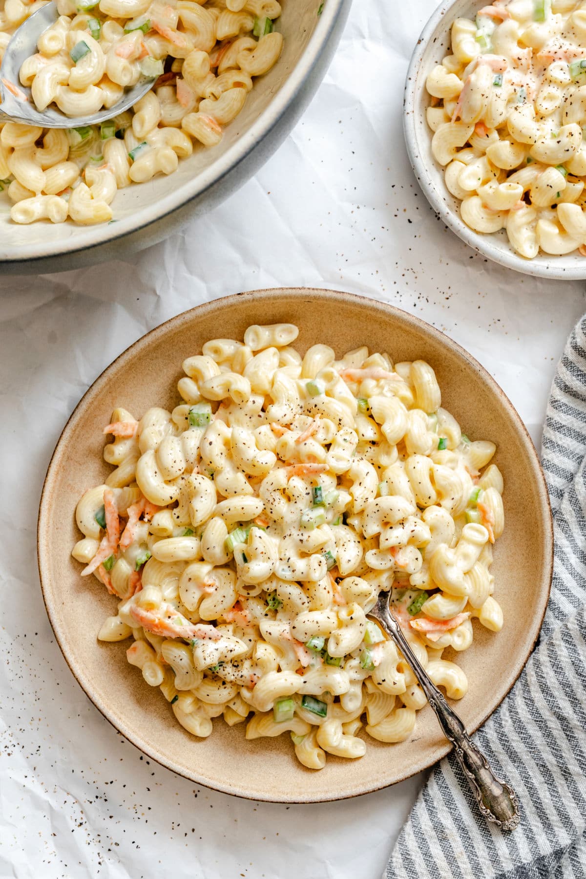 A plate of Hawaiian macaroni salad with a spoon in it.